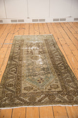 Distressed vintage Hamadan runner showing geometric patterns, sea foam, and worn areas of foundation.