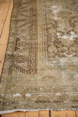 Worn texture of distressed vintage Hamadan runner, showing geometric patterns and exposed foundation.