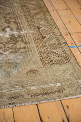 Distressed texture of vintage Hamadan runner, visible foundation, geometric border in faded tones.