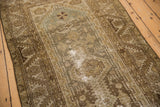 Hamadan runner showing geometric pattern, dusty greens, and exposed foundation wear.