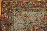 Distressed Qashqai corner: rust borders, ocean blue field, stylized bird motifs, foundation wear.