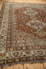 Muted copper and blue tones with distressed texture on a vintage Shiraz carpet border.