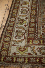 Distressed Vintage Shiraz carpet border features ivory, dark copper, and muted green florals.