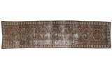 Vintage Distressed Caucasian runner, geometric diamond medallions, earthy tones, heavy foundation wear.