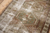 Distressed vintage Caucasian runner's worn pile, exposed foundation, geometric patterns.
