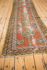 Antique Northwest Persian runner's brick red field with teal hexagonal medallions and softened pile.