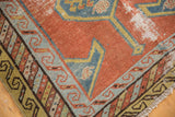 Antique Persian runner corner: brick red field, teal border, saffron accents, and hard wear.