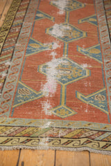 Wear to knot heads and exposed foundation on an antique Northwest Persian rug runner.