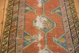 Hard wear on brick red field and teal hexagonal medallions of antique Persian runner.