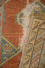 Antique Northwest Persian runner detail: worn brick red pile exposes foundation, hand-knotted back.