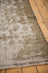 Artfully worn texture of a vintage Malayer rug, with exposed foundation and secured edge.