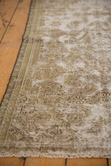 Distressed Malayer rug texture showing visible knot heads and secured side border.