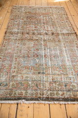 Muted floral bouquets and meandering vine border on a distressed Mahal rug runner.