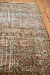 Distressed vintage Mahal rug texture with worn pile, revealing dusty teal and terra cotta.