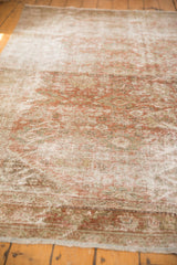 Evenly worn distressed pile of vintage Mahal carpet, muted blush, brown, ivory floral.