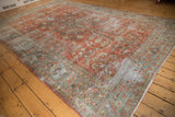 Distressed vintage Mahal rug texture, showing worn red field and ocean green floral border.
