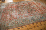 Close-up of distressed Mahal carpet's low pile, revealing muted red, blue, green vinery.