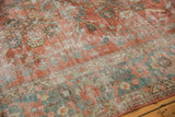 Distressed Mahal carpet's soft red floral vinery, ocean green blue border, and textured worn pile.