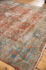 Distressed Mahal rug corner, worn floral vinery, soft red, ocean blue, and exposed foundation.