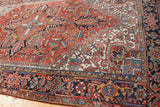 Heriz Carpet with brick red field, navy border, serrated floral motifs, and even low pile.