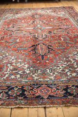 Low pile and intricate brick red, navy, ivory patterns on the vintage Heriz rug border with fringe.