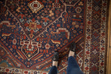 Vintage Shiraz carpet with oversized medallion, vibrant red, cobalt blue, and ivory patterns.