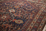 Vintage Shiraz rug showing contrasting navy field with playful geometric-floral motifs and detailed borders.