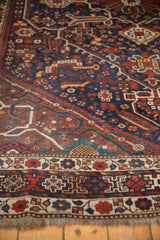 Vintage Persian Shiraz carpet edge with madder red floral and geometric patterns, fringe, and even wear.