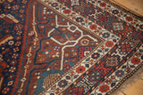 Vintage Shiraz corner: red, blue, ivory floral borders, fringed edge, textured pile.