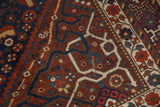 Vintage Shiraz carpet's intricate geometric patterns, playful serpentine lines, and red floral border.