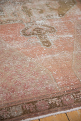 Distressed vintage Oushak texture with low pile, blush, and bronze tones.