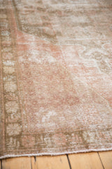 Vintage distressed Oushak runner's texture showing even wear, dusty blush, and antique ivory.
