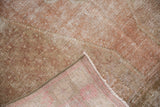 Distressed Oushak rug pile texture, revealing foundation with even wear in blush, ivory tones.