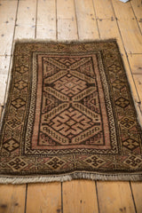 Belouch rug detail: geometric borders, fringe, diamond motifs in chocolate, dusty blush, beige.