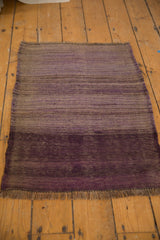 Deep aubergine violet fringe and pronounced horizontal striations of the hand-woven Turkish Kilim.