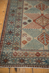 Distressed vintage Afghani rug, close-up of geometric tree motif in seafoam blue and chestnut.