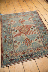 Afghani rug corner, showing distressed finned medallion and germinating tree motifs, sky blue, chestnut borders.
