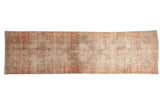 Distressed vintage Oushak runner, faded blush, beige, and gray geometric medallions.