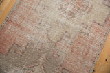 Distressed vintage Oushak runner with mostly even wear, dusty blush and beige geometric motifs.