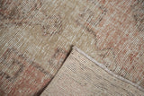Vintage Oushak runner's distressed pile in dusty blush, beige, and silver, showing woven reverse.