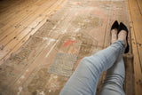 Textural view of a vintage distressed Oushak runner, with pale blush patchwork.