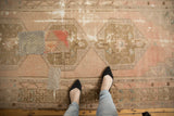 Vintage distressed Oushak runner with playful textile patchwork and wear, pale blush and coffee tones.