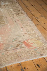 Playful geometric kilim patchwork with pink, orange, and yellow on a distressed Oushak runner.