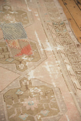 Distressed vintage Oushak rug runner with decorative textile patchwork and exposed foundation.