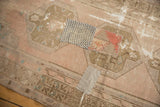Playful patchwork fragments and worn texture on distressed Oushak runner.