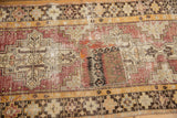 Fragmented flatwoven kilim patchwork on distressed vintage Oushak rug runner, showing geometric motifs.