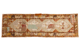 Distressed vintage Oushak runner, patchwork and geometric medallions in muted earth tones. 2'10