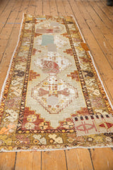Distressed Oushak runner section with geometric design, pale blue and red patchwork.