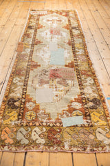 Distressed Oushak runner detail with visible patchwork and saffron, dusty red border.