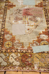 Close-up of distressed Oushak runner showing pale blue and tan fabric patchwork.